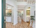 Inviting foyer with tile floors and white trim offers a glimpse into the kitchen and dining areas at 1134 Shadow Lake Cir # 55, Mount Pleasant, SC 29464
