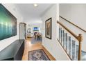 Bright foyer with hardwood floors, stairway, and open view to living and dining area at 118 Congress St # F, Charleston, SC 29403