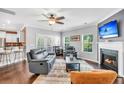 Inviting living room with hardwood floors, a cozy fireplace, and abundant natural light from the multiple windows at 123 Mcdonald Ct, Summerville, SC 29485