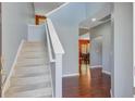 Bright foyer with hardwood floors, staircase and views of the dining area at 134 Longford Dr, Summerville, SC 29483