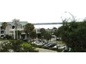 Exterior view of a building near the water featuring well-maintained landscaping at 14 Lockwood Dr # 2E, Charleston, SC 29401
