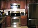 The kitchen offers stainless steel appliances and wooden cabinets with granite countertops at 14 Lockwood Dr # 2E, Charleston, SC 29401