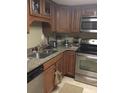 Kitchen with stainless steel appliances, granite countertops, and wooden cabinets at 14 Lockwood Dr # 2E, Charleston, SC 29401