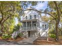 Charming two-story home with a welcoming porch, garage, set amongst lush greenery in a serene neighborhood at 1470 Eutaw Battalion Dr, Charleston, SC 29412