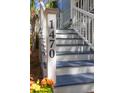 Close-up of the house number '1470' on the staircase post with vibrant flowers, showing great curb appeal at 1470 Eutaw Battalion Dr, Charleston, SC 29412