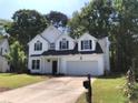 Charming two-story home featuring black shutters, an attached two-car garage, and a well-manicured lawn at 1496 Cypress Pointe Dr, Mount Pleasant, SC 29466