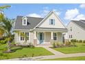 Inviting single-story home showcasing a well-kept lawn and a turquoise front door at 154 Helena Park Dr, Summerville, SC 29486