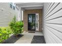 Inviting entryway with brick accents and a black-framed glass front door at 169 Longford Dr, Summerville, SC 29483