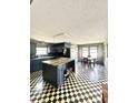 Open concept kitchen with a large island and a checkered floor at 1805 Wood Duck Rd, Moncks Corner, SC 29461