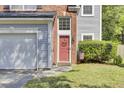 Close-up of a front door area featuring a brick entryway, siding, and well-manicured landscaping at 1954 Treebark Dr, Charleston, SC 29414