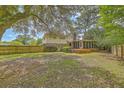 Spacious fenced backyard with a large deck and screened-in porch, perfect for outdoor entertaining at 2042 Dogwood Rd, Charleston, SC 29414