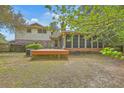 Large wooden deck and screened-in porch offer a great view of the private fenced backyard at 2042 Dogwood Rd, Charleston, SC 29414