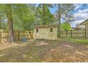 Backyard features a weathered wooden shed with a fenced yard, perfect for storage at 2042 Dogwood Rd, Charleston, SC 29414
