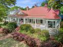 This home features a charming gazebo, front porch, and lush landscaping at 210 S Gum St, Summerville, SC 29483
