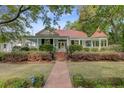 Inviting home with a brick walkway, well-manicured lawn, and a charming gazebo at 210 S Gum St, Summerville, SC 29483