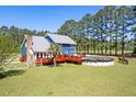 Backyard view of home with wooden deck and above ground pool at 2102 Williams Rd, Ruffin, SC 29475