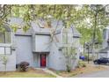 Charming gray townhouse featuring a striking red front door and distinctive arched window at 2159 Spoleto Ln # E, North Charleston, SC 29406
