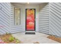 A charming red front door with sidelight and 'hello' welcome mat invites you inside at 2159 Spoleto Ln # E, North Charleston, SC 29406