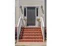Inviting front entrance with brick steps, decorative flower pots and sidelight windows at 2290 Deer Sight Way, Mount Pleasant, SC 29466