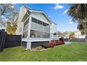 Inviting backyard featuring a screened porch, well maintained grass, and mature landscape at 2292 Skyler Dr, Mount Pleasant, SC 29466