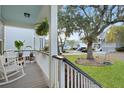 Cozy front porch with rocking chairs, hanging plants, and views of the neighborhood street at 2292 Skyler Dr, Mount Pleasant, SC 29466