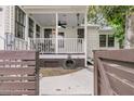 This rear covered porch features a ceiling fan and outdoor dining area at 24 Hanover St, Charleston, SC 29403