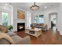 Bright living room with a fireplace, hardwood floors, and stylish furniture, creating a cozy and inviting atmosphere at 2405 Louisville St, Charleston, SC 29492