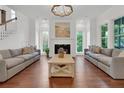 Elegant living room with hardwood floors, fireplace, and beach painting, creating a comfortable and welcoming atmosphere at 2405 Louisville St, Charleston, SC 29492