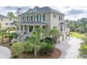 Stately two-story home features a large front porch and three-car garage at 2444 Darts Cove Way, Mount Pleasant, SC 29466