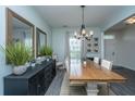 Elegant dining room with a large wooden table, stylish lighting, and decor, ideal for gatherings at 249 Oak View Way, Summerville, SC 29483
