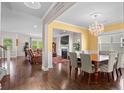 Formal dining room showcasing elegant chandelier and hardwood floors, open to living room at 2840 Conservancy Ln, Charleston, SC 29414