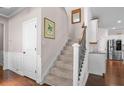 Inviting staircase with decorative wrought iron spindles and wooden handrail to the upper level at 2840 Conservancy Ln, Charleston, SC 29414