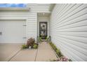 Entrance of home with well kept landscaping and an oversized two car garage at 293 Firewheel Ct, Summerville, SC 29486