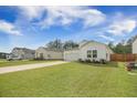 Street view of home and yard with long driveway, landscaped lawn in a suburban neighborhood at 293 Firewheel Ct, Summerville, SC 29486