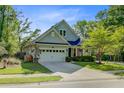 Charming two-story home with well-manicured lawn, attached garage, and inviting front porch at 3001 Grand Bay Ln, Johns Island, SC 29455
