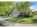 Charming two-story home with well-manicured lawn, attached garage, and inviting front porch at 3001 Grand Bay Ln, Johns Island, SC 29455
