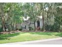 Beautiful home exterior with established landscaping, mature trees and classic architectural details at 3023 Maritime Forest Dr, Johns Island, SC 29455