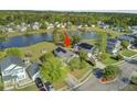 Scenic aerial view showcases a well-maintained house with solar panels and a backyard overlooking a lake at 318 Seneca River Dr, Summerville, SC 29485