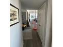 Long hallway with hardwood floors leading to multiple rooms and natural light at 330 Concord St # 14D, Charleston, SC 29401