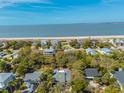Aerial view of a coastal neighborhood, with a golden star on the roof to highlight the listing at 3308 Myrtle St, Edisto Beach, SC 29438
