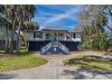 Charming coastal home with elevated design, staircase entry, and quaint front porch at 3308 Myrtle St, Edisto Beach, SC 29438