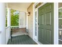 Cozy front porch with a bench, column supports, and a charming olive-green front door at 339 Clayton Dr, Charleston, SC 29414