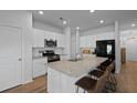 Bright kitchen features an island with bar seating, granite countertops and stainless steel appliances at 341 Matuskovic Dr, Charleston, SC 29414