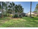 Serene backyard featuring green grass, mature trees, and an inviting patio area at 347 Prestwick Ct, Summerville, SC 29483
