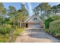 Inviting home with manicured landscaping, two-car garage, and a welcoming front entrance at 347 Prestwick Ct, Summerville, SC 29483
