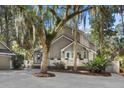 Attractive home with a well-manicured yard, a front porch, and a blue door at 3510 Deer Run Rd, Seabrook Island, SC 29455