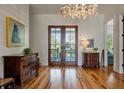Bright foyer featuring hardwood floors, elegant decor, and double doors at 409 W Indian Ave, Folly Beach, SC 29439