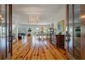 Open-concept living area with hardwood floors and an abundance of natural light at 409 W Indian Ave, Folly Beach, SC 29439