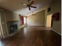 Inviting living room featuring hardwood floors, a fireplace, and a ceiling fan at 411 Navaho Cir, Summerville, SC 29483