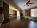 Spacious living room with hardwood floors, vaulted ceilings, and a cozy fireplace at 411 Navaho Cir, Summerville, SC 29483